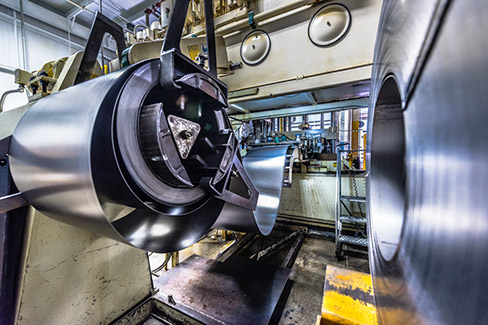 A 36-inch wide steel coil being fed into one of Larson Tool & Stamping's deep drawn transfer press lines.