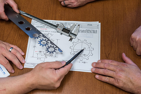 Larson Tool & Stamping employees reviewing design specifications for a custom tool.